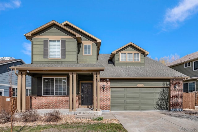 traditional home with concrete driveway, brick siding, and fence