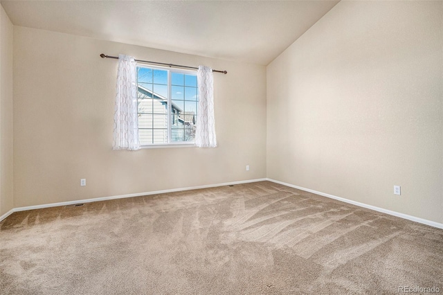 unfurnished room with carpet and baseboards