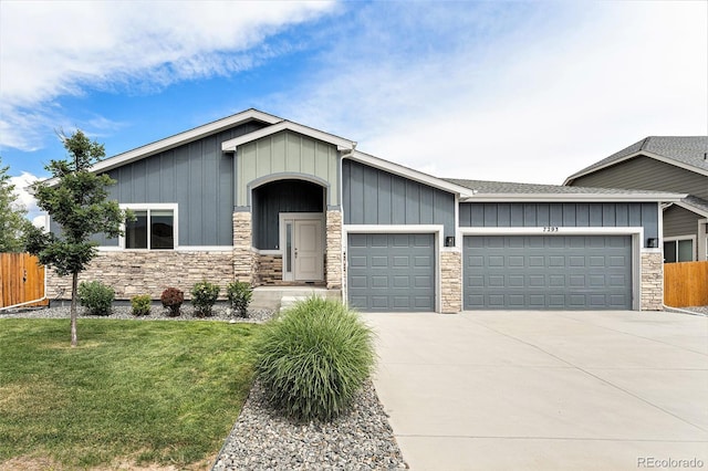 7293 Xenophon Ct, Arvada, CO 80004 - craftsman house with stone siding, a garage, board and batten siding, driveway, and roof with shingles