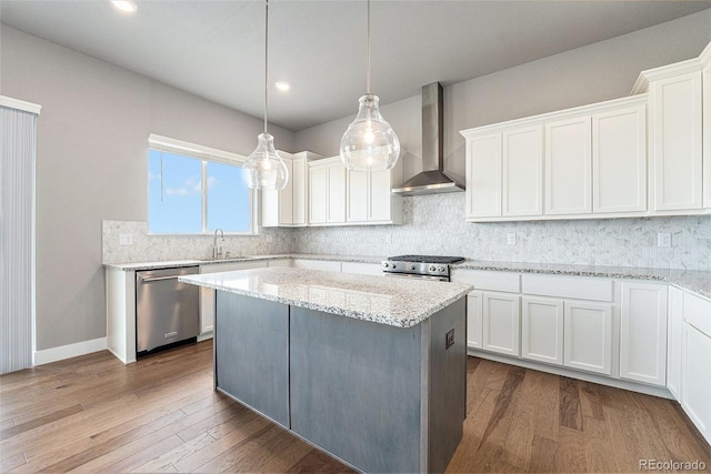 7293 Xenophon Ct, Arvada, CO 80004 - kitchen featuring stainless steel appliances, wall chimney range hood, white cabinetry, decorative backsplash, and recessed lighting
