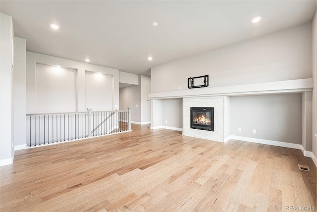 7293 Xenophon Ct, Arvada, CO 80004 - unfurnished living room featuring light wood finished floors, recessed lighting, and a tile fireplace