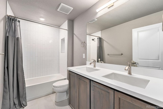 7293 Xenophon Ct, Arvada, CO 80004 - bathroom with double vanity, shower / bath combo with shower curtain, tile patterned floors, and a textured ceiling
