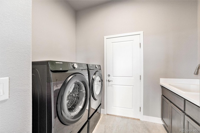 7293 Xenophon Ct, Arvada, CO 80004 - laundry room with washing machine and dryer and cabinet space