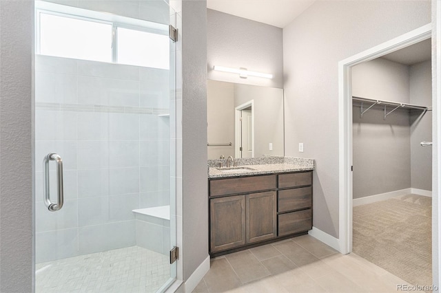 7293 Xenophon Ct, Arvada, CO 80004 - full bath with a shower stall, vanity, a walk in closet, and tile patterned flooring