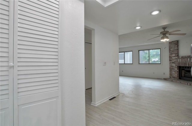 corridor with light hardwood / wood-style flooring