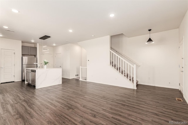 3805 N Himalaya Rd Unit 1, Denver, CO 80249 - unfurnished living room with dark wood-type flooring, recessed lighting, and stairs
