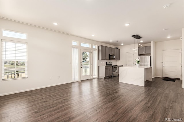 3805 N Himalaya Rd Unit 1, Denver, CO 80249 - unfurnished living room with dark wood-style flooring and recessed lighting