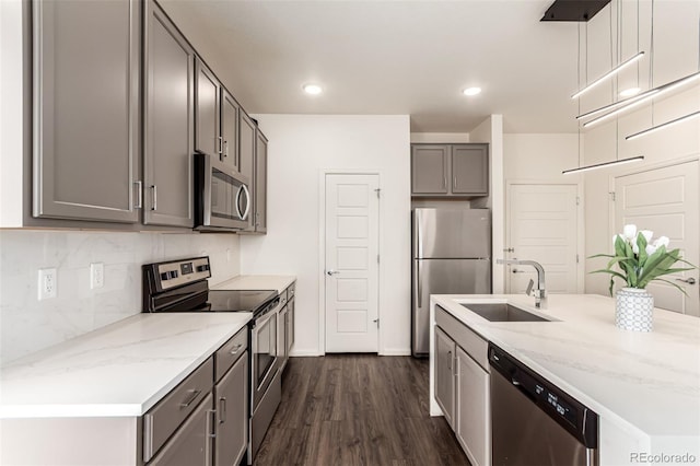 3805 N Himalaya Rd Unit 1, Denver, CO 80249 - kitchen with appliances with stainless steel finishes, gray cabinets, dark wood-style floors, tasteful backsplash, and recessed lighting