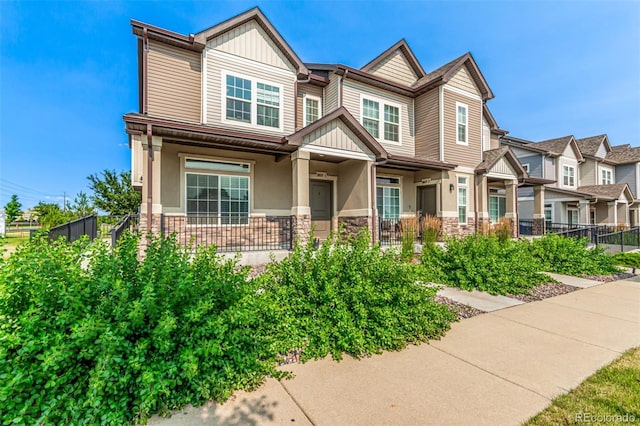 3805 N Himalaya Rd Unit 1, Denver, CO 80249 - craftsman inspired home with board and batten siding, a porch, and stone siding