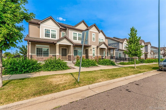 3805 N Himalaya Rd Unit 1, Denver, CO 80249 - craftsman-style home featuring a residential view, stone siding, and covered porch