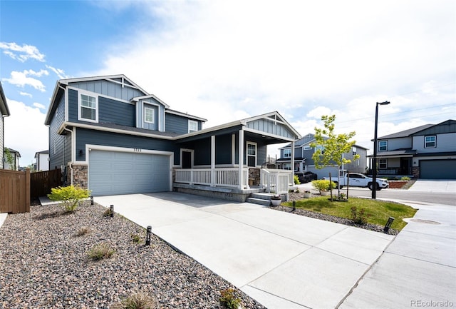 3722 Sandy Vista Trl, Castle Rock, CO 80104 - view of front of home featuring board and batten siding, covered porch, driveway, an attached garage, and stone siding