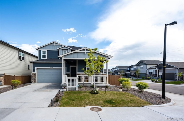 3722 Sandy Vista Trl, Castle Rock, CO 80104 - craftsman house featuring a porch, board and batten siding, driveway, a garage, and a residential view