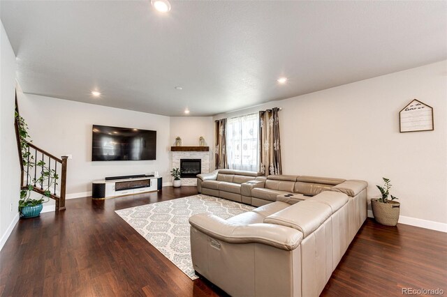 3722 Sandy Vista Trl, Castle Rock, CO 80104 - living area featuring wood finished floors, recessed lighting, baseboards, stairs, and a stone fireplace
