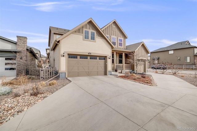 view of front of house with an attached garage, fence, board and batten siding, and concrete driveway