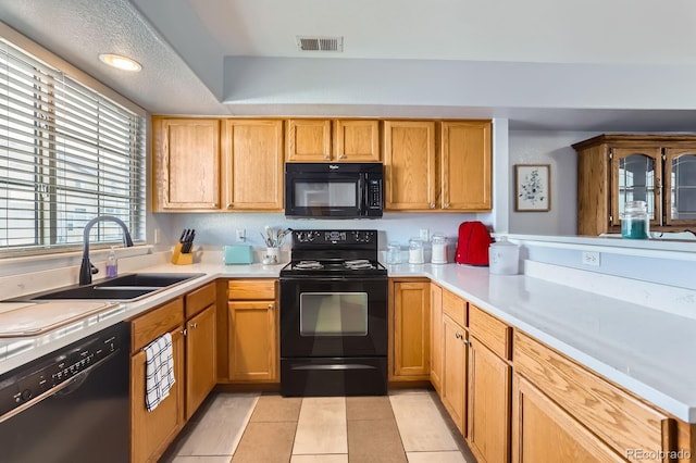 8199 Welby Rd Unit 3102, Denver, CO 80229 - kitchen featuring black appliances, a sink, light countertops, light tile patterned floors, and recessed lighting