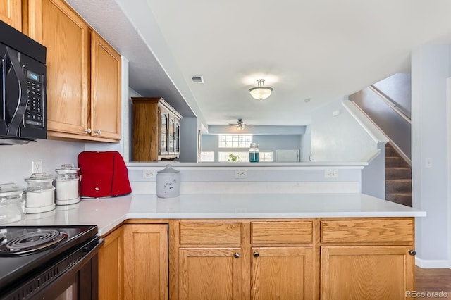 8199 Welby Rd Unit 3102, Denver, CO 80229 - kitchen featuring black appliances, light countertops, a ceiling fan, and a peninsula