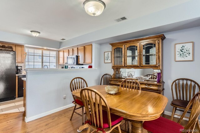 8199 Welby Rd Unit 3102, Denver, CO 80229 - dining area with light wood-style floors and baseboards