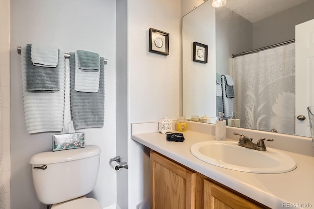 8199 Welby Rd Unit 3102, Denver, CO 80229 - bathroom featuring toilet, vanity, and a shower with shower curtain