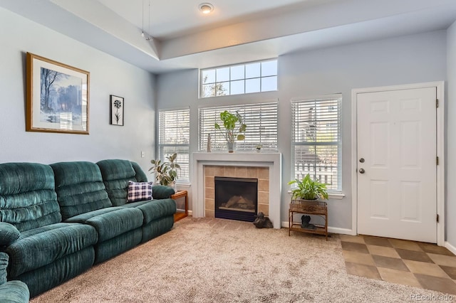 8199 Welby Rd Unit 3102, Denver, CO 80229 - living area featuring a tiled fireplace and baseboards