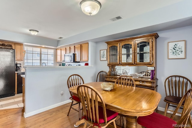 8199 Welby Rd Unit 3102, Denver, CO 80229 - dining area with light wood-style flooring and baseboards