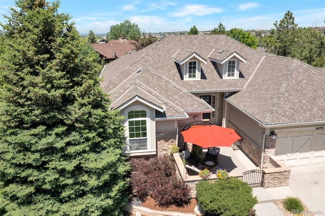 24733 E Park Crescent Dr, Aurora, CO 80016 - view of front of home with roof with shingles, an attached garage, stone siding, a gate, and stucco siding