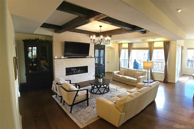 24733 E Park Crescent Dr, Aurora, CO 80016 - living area featuring a stone fireplace, wood finished floors, a chandelier, coffered ceiling, and beam ceiling