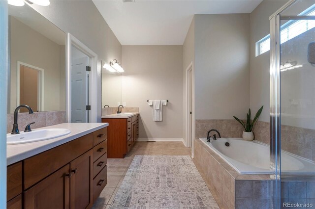 24733 E Park Crescent Dr, Aurora, CO 80016 - bathroom featuring two vanities, tile patterned floors, and a bath