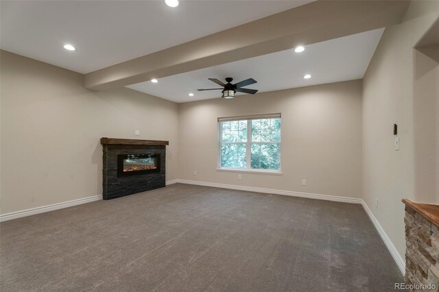 24733 E Park Crescent Dr, Aurora, CO 80016 - unfurnished living room with a ceiling fan, dark colored carpet, recessed lighting, and a stone fireplace