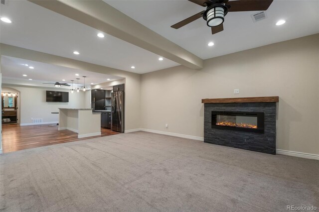 24733 E Park Crescent Dr, Aurora, CO 80016 - unfurnished living room featuring a ceiling fan, carpet flooring, recessed lighting, and a stone fireplace