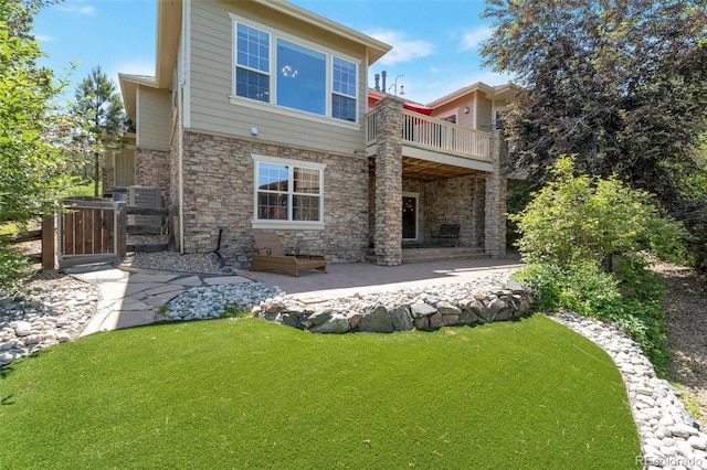 24733 E Park Crescent Dr, Aurora, CO 80016 - back of house with a lawn, stone siding, a patio, and a balcony