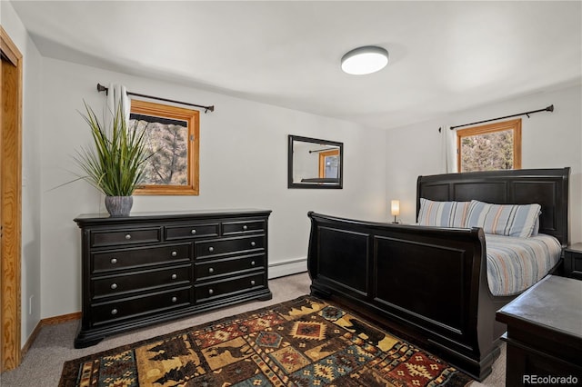 carpeted bedroom with a baseboard heating unit