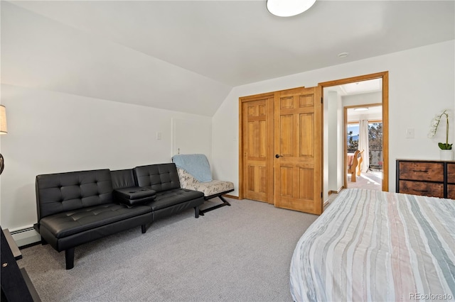 bedroom featuring a baseboard heating unit, light colored carpet, and vaulted ceiling