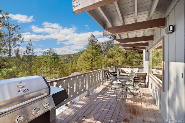 wooden deck featuring a grill