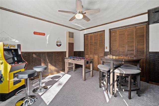 playroom featuring carpet flooring, ceiling fan, and ornamental molding