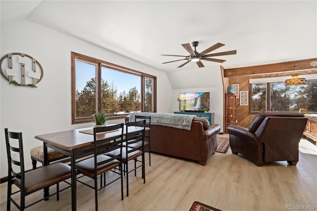 living room with ceiling fan, vaulted ceiling, and light hardwood / wood-style flooring