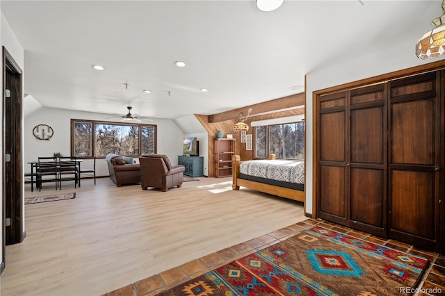 bedroom with light hardwood / wood-style floors and vaulted ceiling