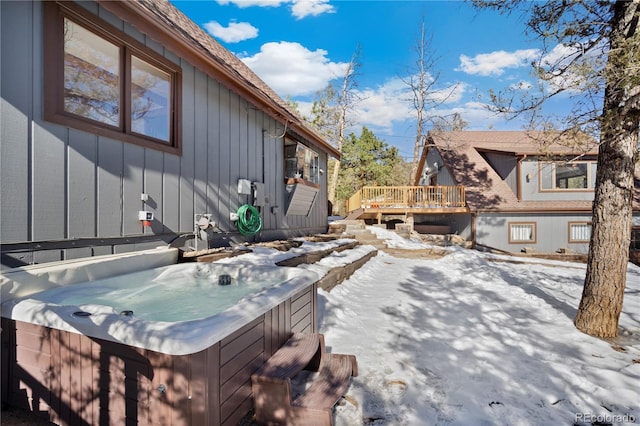 snow covered deck featuring a hot tub