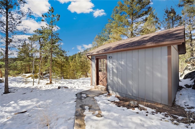 view of snowy exterior featuring an outdoor structure