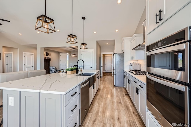 229 High Meadows Loop, Elizabeth, CO 80107 - kitchen with stainless steel appliances, light wood-type flooring, white cabinetry, a large island with sink, and pendant lighting