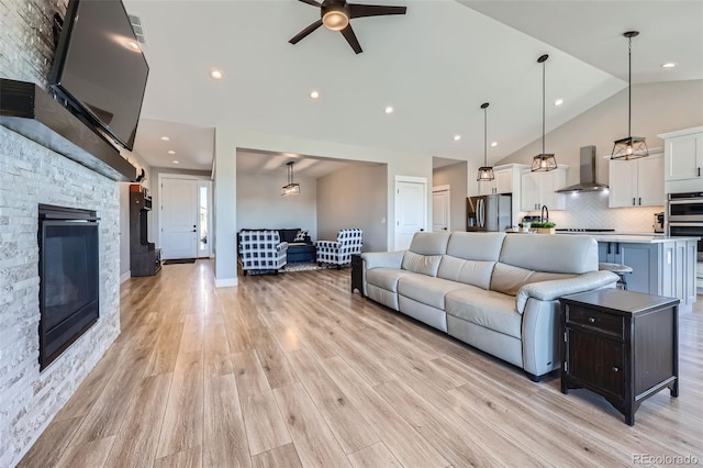 229 High Meadows Loop, Elizabeth, CO 80107 - living area with ceiling fan, light wood-type flooring, a fireplace, high vaulted ceiling, and recessed lighting