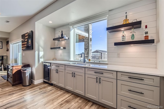 229 High Meadows Loop, Elizabeth, CO 80107 - kitchen featuring open shelves, beverage cooler, light wood-style floors, gray cabinets, and light countertops