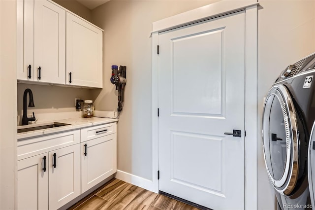 229 High Meadows Loop, Elizabeth, CO 80107 - laundry area with washer / dryer, cabinet space, and light wood finished floors