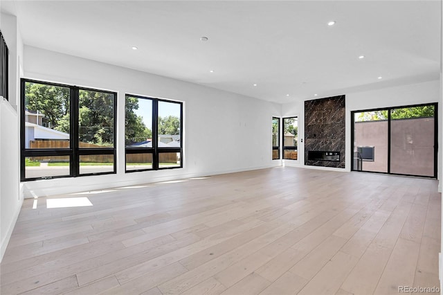 1491 S York St, Denver, CO 80210 - unfurnished living room with recessed lighting and light wood-style floors