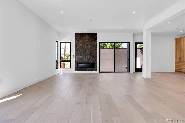 1491 S York St, Denver, CO 80210 - unfurnished living room featuring a fireplace, recessed lighting, and light wood-style flooring
