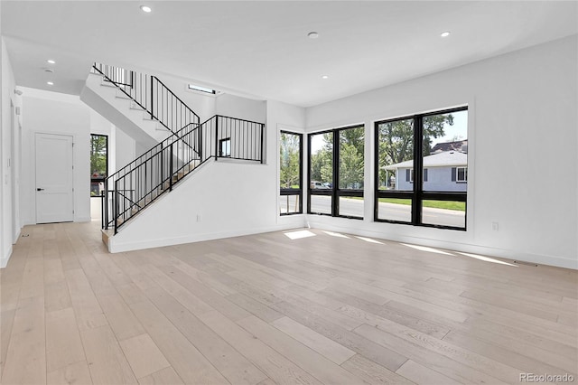 1491 S York St, Denver, CO 80210 - unfurnished living room with light wood finished floors, recessed lighting, and stairs