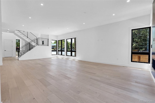 1491 S York St, Denver, CO 80210 - unfurnished living room featuring stairs, recessed lighting, and light wood finished floors