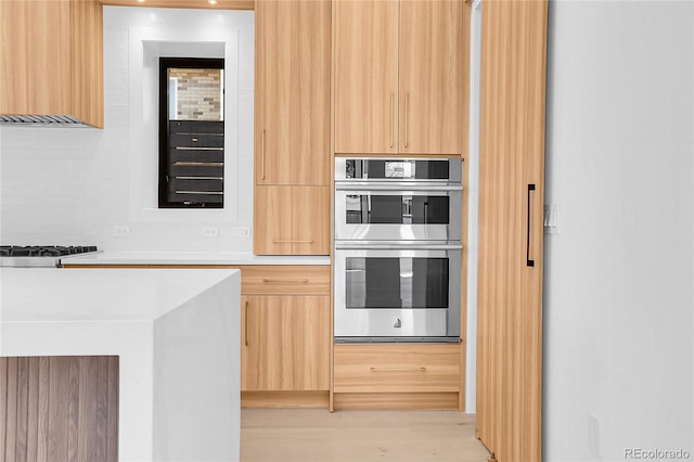 1491 S York St, Denver, CO 80210 - kitchen featuring modern cabinets, stainless steel double oven, and light brown cabinetry