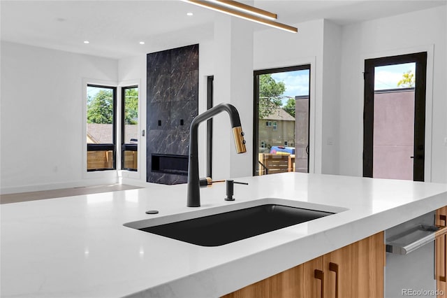 1491 S York St, Denver, CO 80210 - kitchen featuring light countertops, modern cabinets, brown cabinetry, and recessed lighting