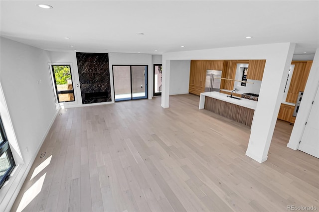 1491 S York St, Denver, CO 80210 - unfurnished living room featuring recessed lighting and light wood-style floors