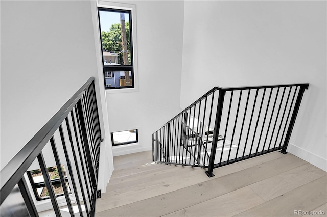 1491 S York St, Denver, CO 80210 - stairway featuring wood finished floors and baseboards